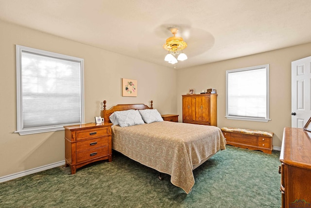 bedroom with multiple windows, ceiling fan, and dark colored carpet