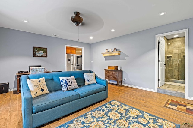 living room with hardwood / wood-style flooring and ceiling fan