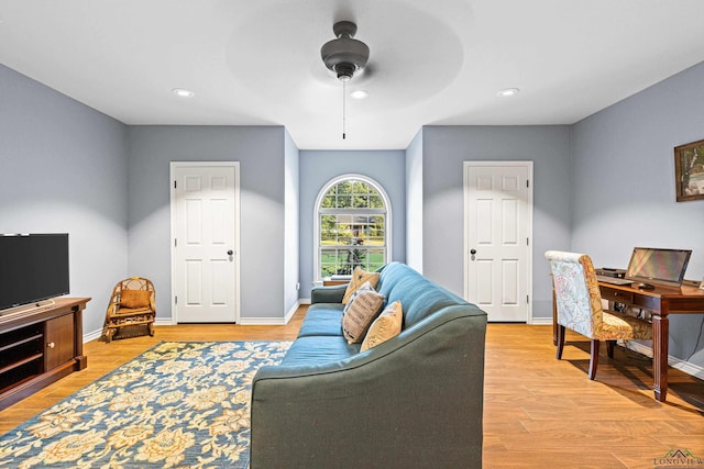 living room featuring ceiling fan and light hardwood / wood-style floors