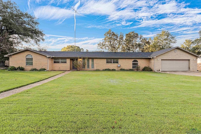 single story home featuring a garage and a front lawn