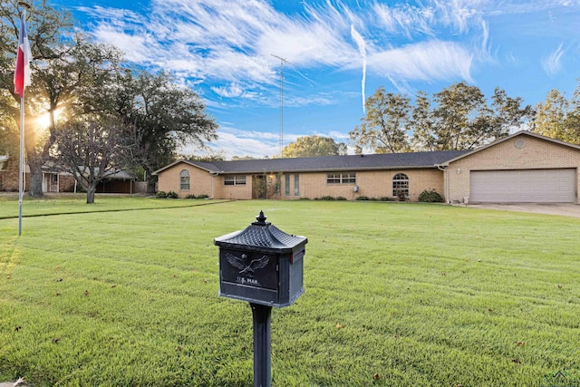 view of front of home with a front lawn and a garage