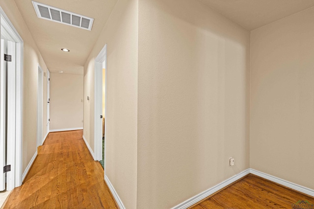 hall with hardwood / wood-style floors