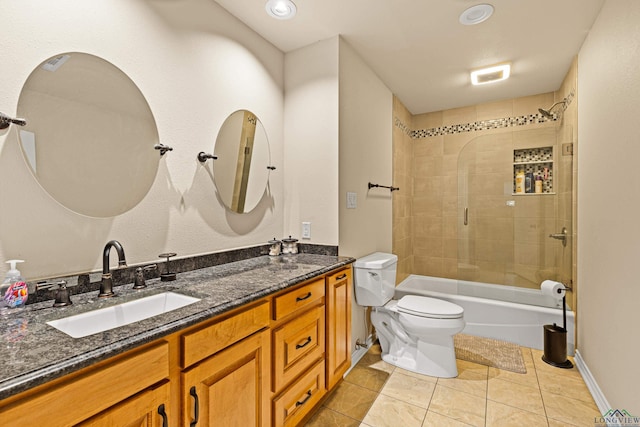 full bathroom featuring toilet, tile patterned flooring, vanity, and tiled shower / bath