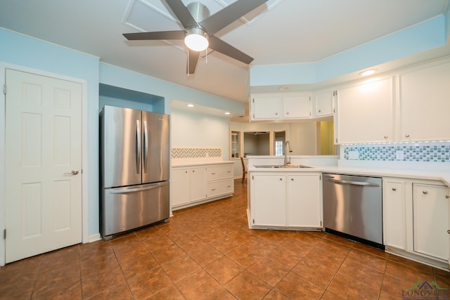 kitchen featuring appliances with stainless steel finishes, tasteful backsplash, ceiling fan, sink, and white cabinetry