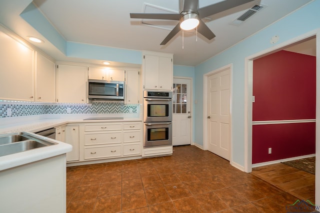 kitchen featuring white cabinets, sink, decorative backsplash, ceiling fan, and stainless steel appliances