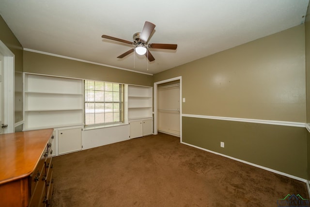 interior space with dark colored carpet and ceiling fan