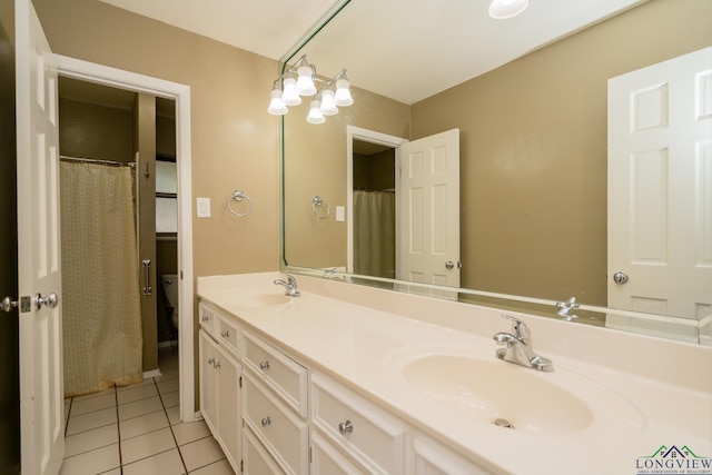 bathroom featuring tile patterned floors, vanity, and toilet