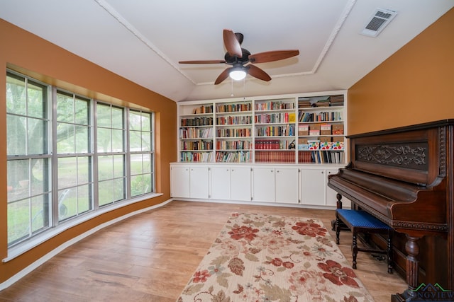 misc room with light hardwood / wood-style floors, vaulted ceiling, ceiling fan, and a healthy amount of sunlight