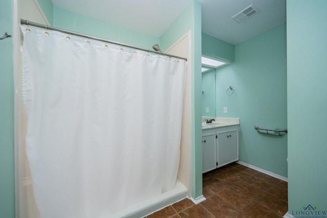 bathroom with curtained shower and vanity