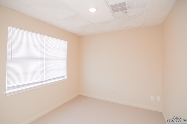 unfurnished room with a paneled ceiling