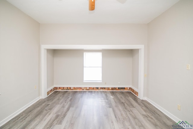 unfurnished room with ceiling fan and light hardwood / wood-style floors