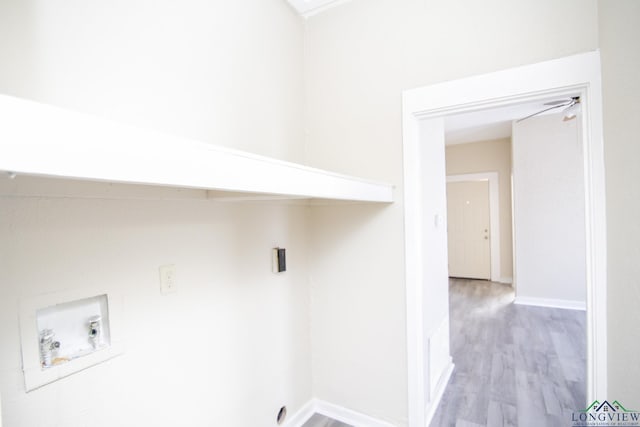 washroom with hookup for a washing machine and light hardwood / wood-style flooring