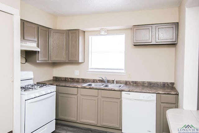 kitchen with white appliances, gray cabinets, and sink