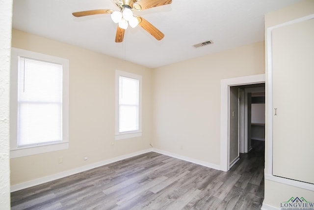 spare room featuring hardwood / wood-style flooring and ceiling fan