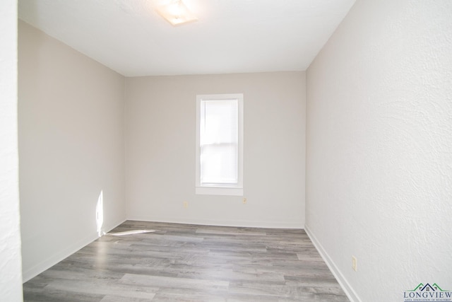 spare room featuring light wood-type flooring