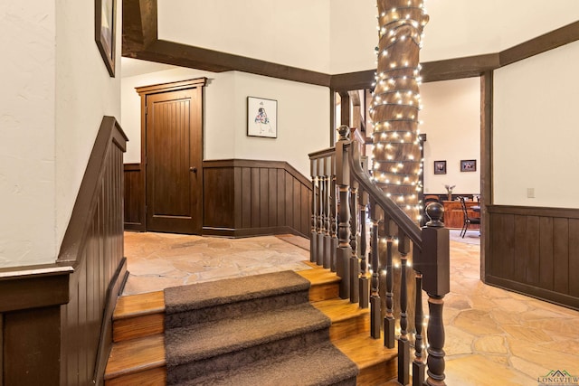 staircase with a chandelier