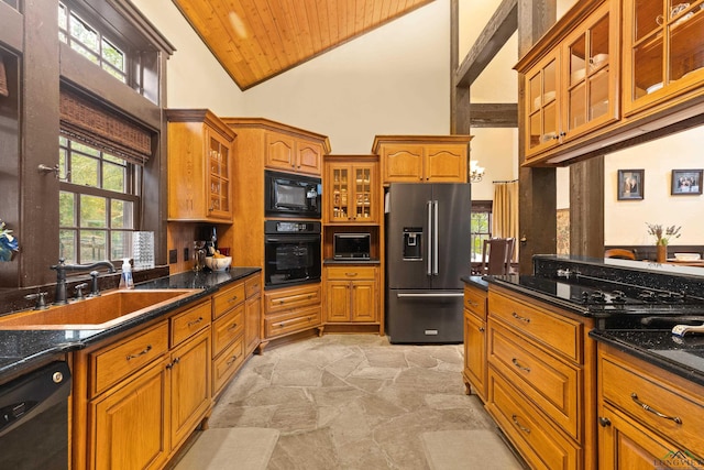 kitchen featuring sink, high vaulted ceiling, dark stone countertops, black appliances, and wood ceiling