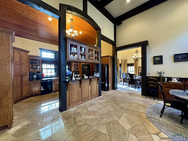 kitchen with decorative light fixtures, an inviting chandelier, and black appliances