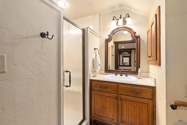 bathroom featuring a shower with door, vanity, and lofted ceiling