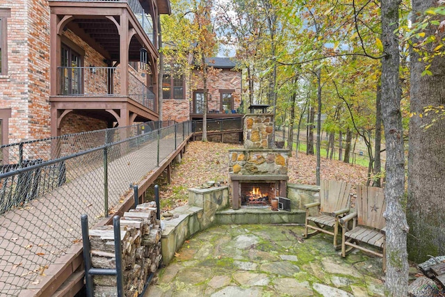 view of patio with an outdoor stone fireplace