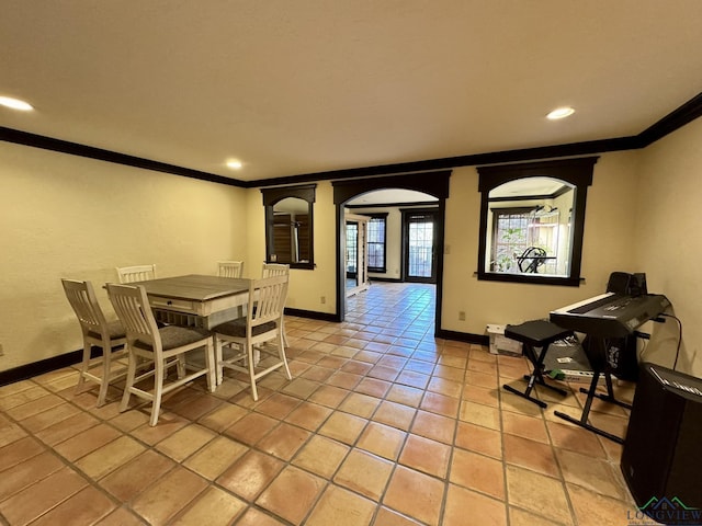 dining space featuring light tile patterned flooring and ornamental molding