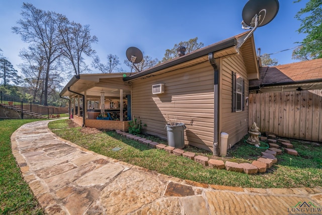 rear view of property featuring a wall mounted AC