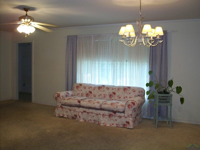 unfurnished living room with crown molding, carpet floors, and ceiling fan with notable chandelier