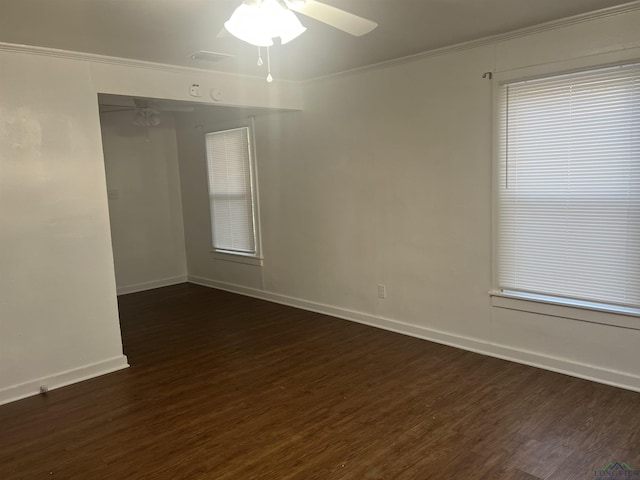 spare room with dark hardwood / wood-style flooring, ornamental molding, and ceiling fan