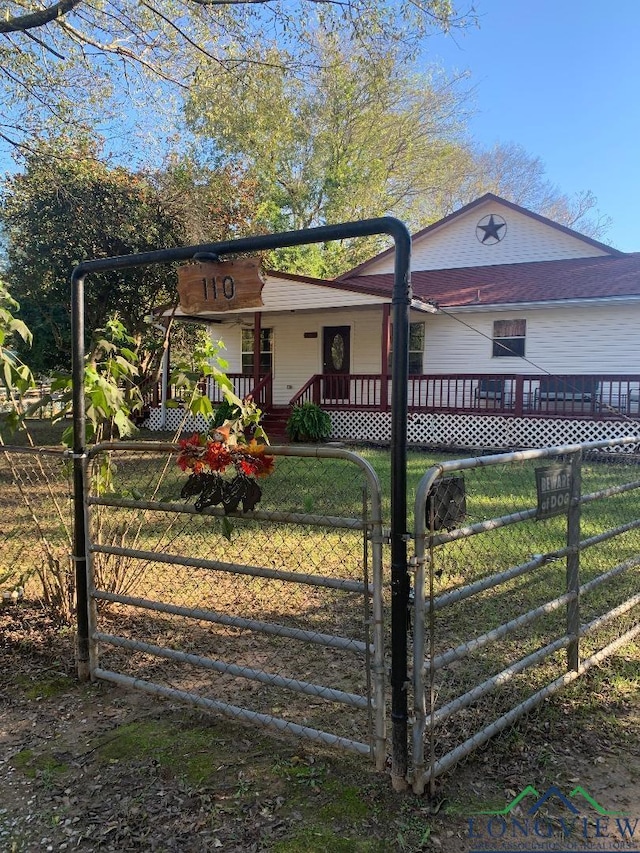 ranch-style house with covered porch and a front lawn