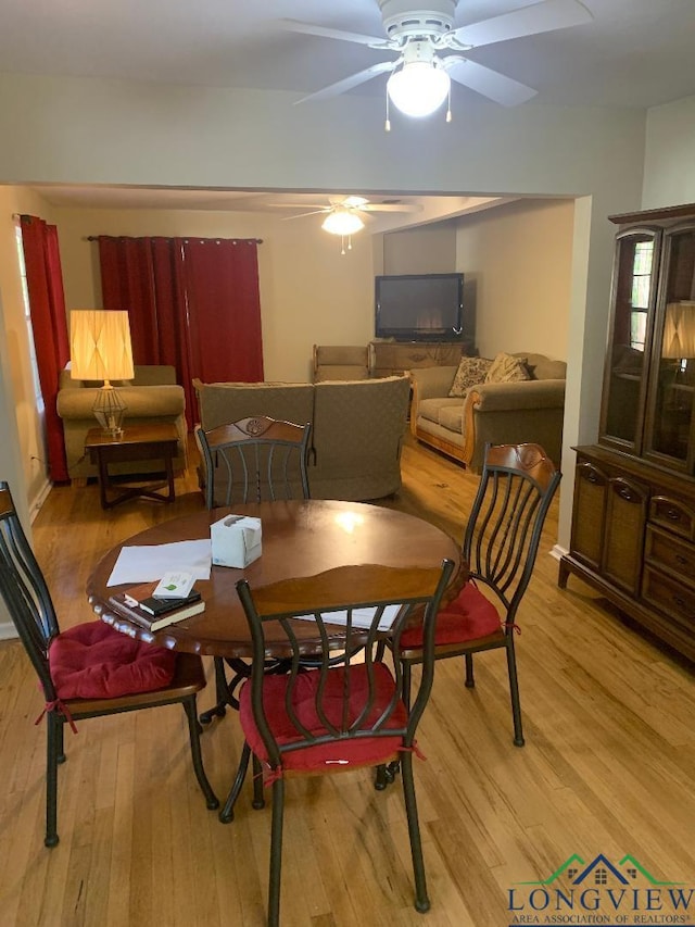 dining space with ceiling fan and hardwood / wood-style floors