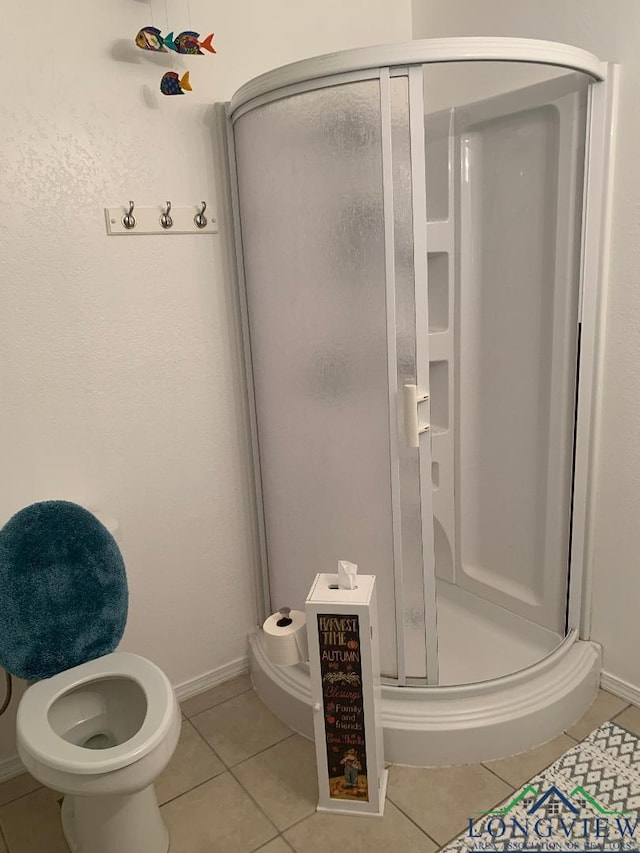 bathroom featuring tile patterned floors and an enclosed shower