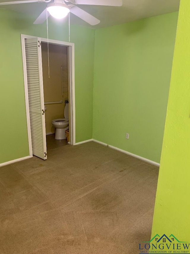 unfurnished bedroom with carpet floors, a closet, ceiling fan, and ensuite bathroom