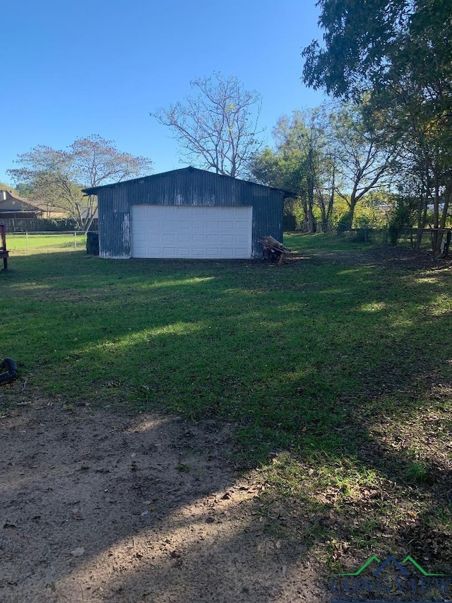 view of yard featuring a garage and an outdoor structure