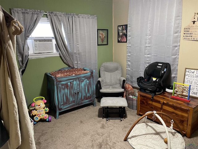 bedroom with cooling unit, carpet floors, and a crib