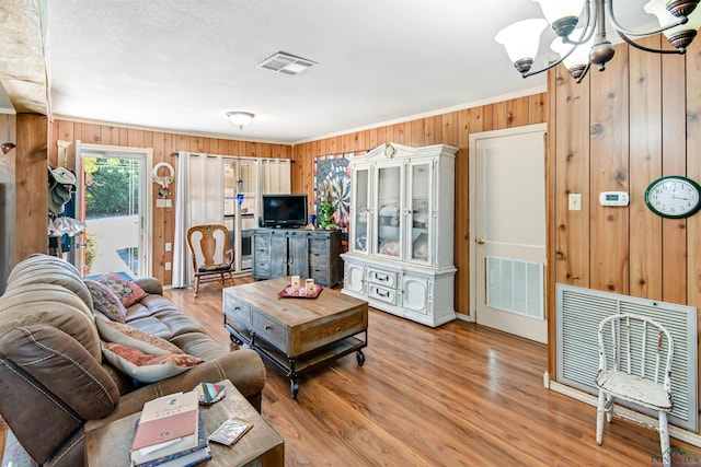 living room with hardwood / wood-style flooring and a notable chandelier