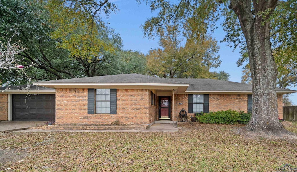 ranch-style house with a garage and a front yard