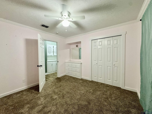 2305 Buccaneer Dr, Longview, TX 75604 - unfurnished bedroom featuring dark colored carpet, ornamental molding, a textured ceiling, ceiling fan, and baseboards