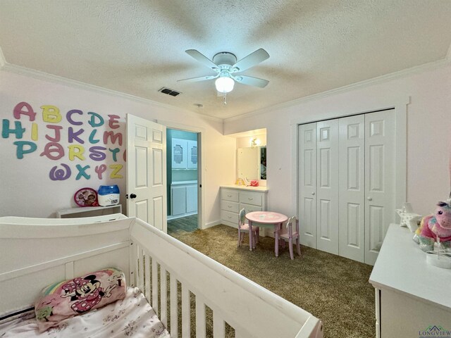 2305 Buccaneer Dr, Longview, TX 75604 - bedroom with crown molding, dark colored carpet, a closet, a textured ceiling, and a ceiling fan