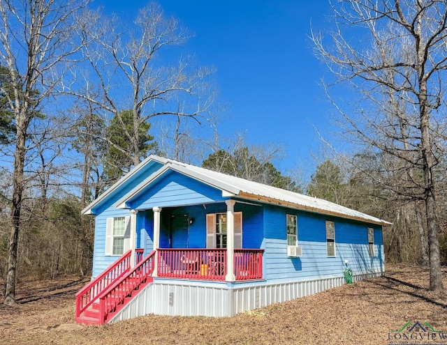 view of front of house with covered porch and metal roof