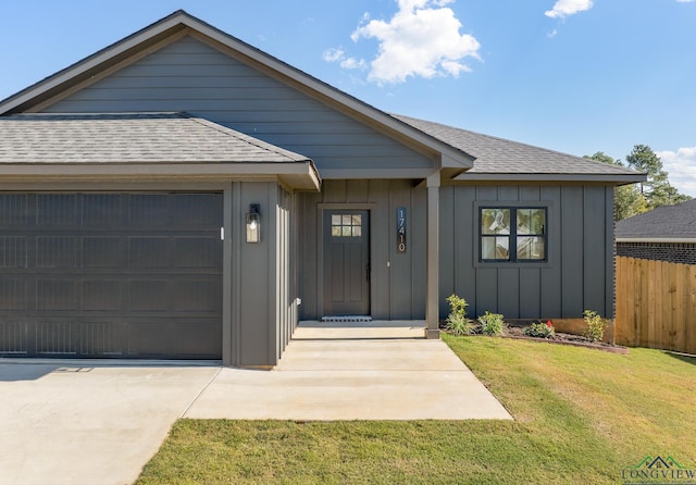 ranch-style home featuring a garage and a front lawn