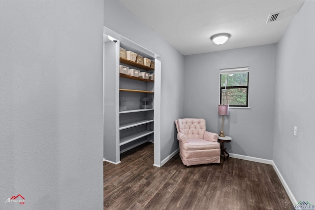 living area featuring dark wood finished floors and baseboards