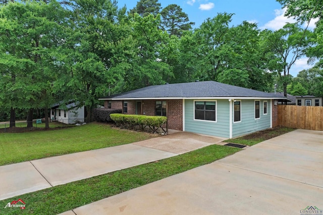 single story home with driveway and brick siding