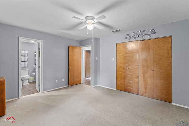 unfurnished bedroom featuring carpet floors, a closet, baseboards, and a textured ceiling