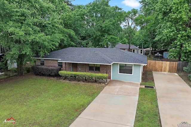 ranch-style house featuring driveway, roof with shingles, and brick siding