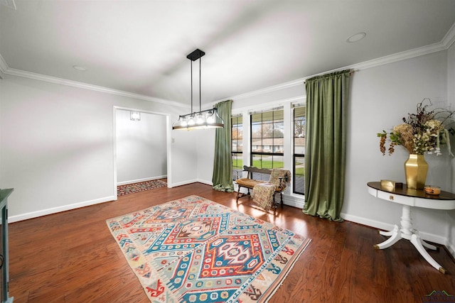 sitting room with dark hardwood / wood-style floors and crown molding