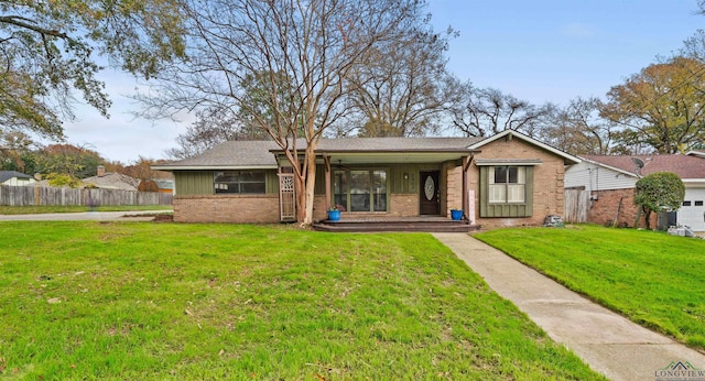 ranch-style house with covered porch and a front lawn