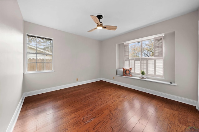 spare room featuring ceiling fan and dark wood-type flooring