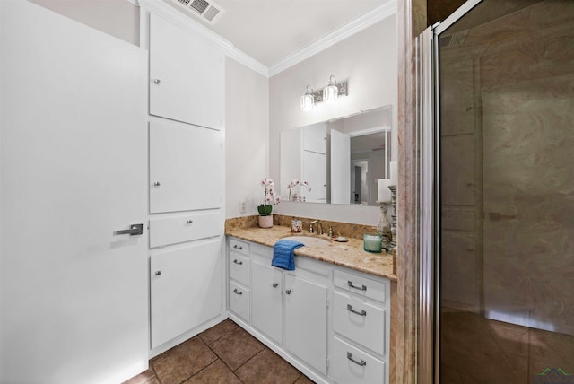 bathroom featuring crown molding, tile patterned flooring, and vanity