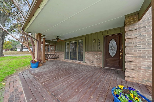 wooden terrace with ceiling fan and covered porch