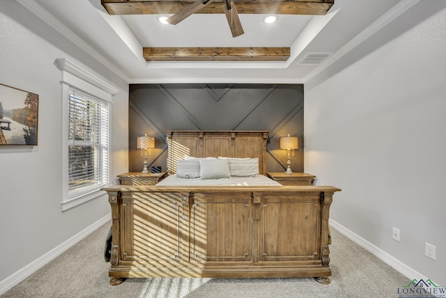 carpeted bedroom featuring a raised ceiling and ceiling fan